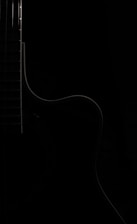 A minimalist image of a classical guitar intertwined with electronic music elements.