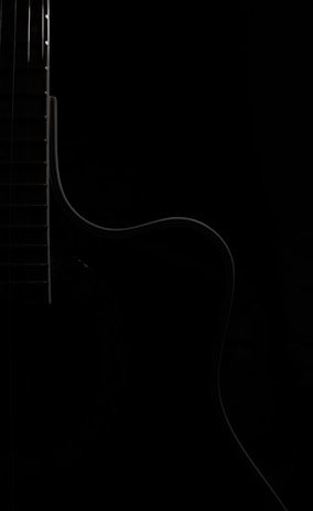 A minimalist image of a classical guitar intertwined with electronic music elements.