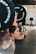 A smiling woman holding a barbell, celebrating a new personal best.