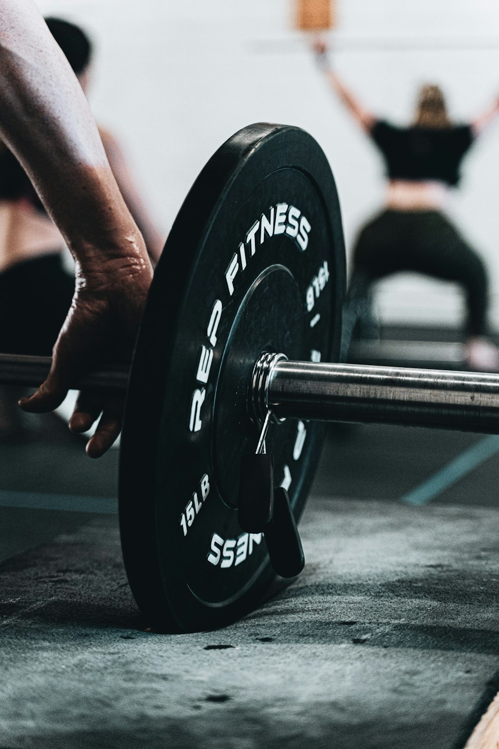 person holding black and silver dumbbell