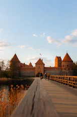 people walking on gray concrete bridge near brown concrete building during daytime