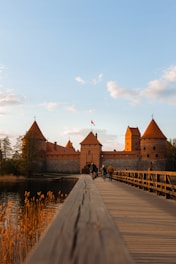 people walking on gray concrete bridge near brown concrete building during daytime