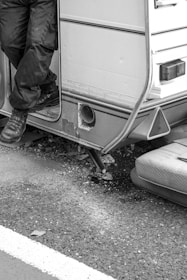 A technician inspecting a camper for damage.