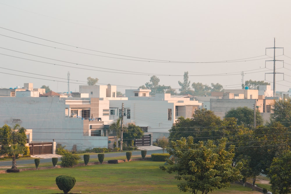 green grass field near white concrete building during daytime