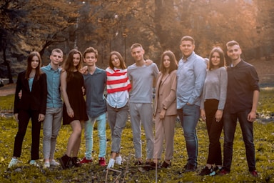 photography poses for big groups,how to photograph friends; group of people standing on green grass field during daytime