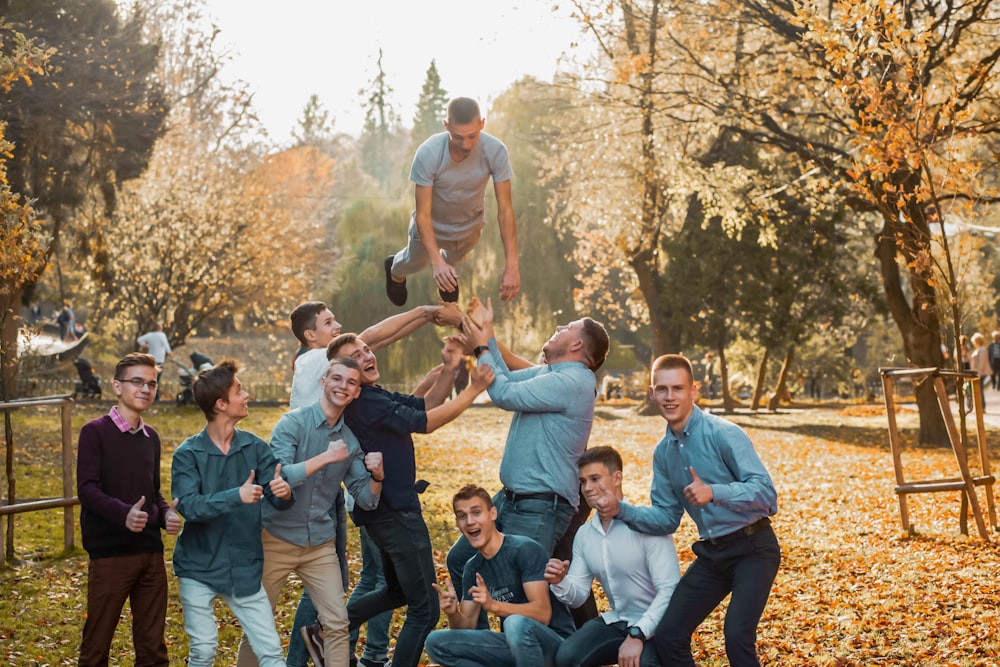 group of people sitting on grass field during daytime