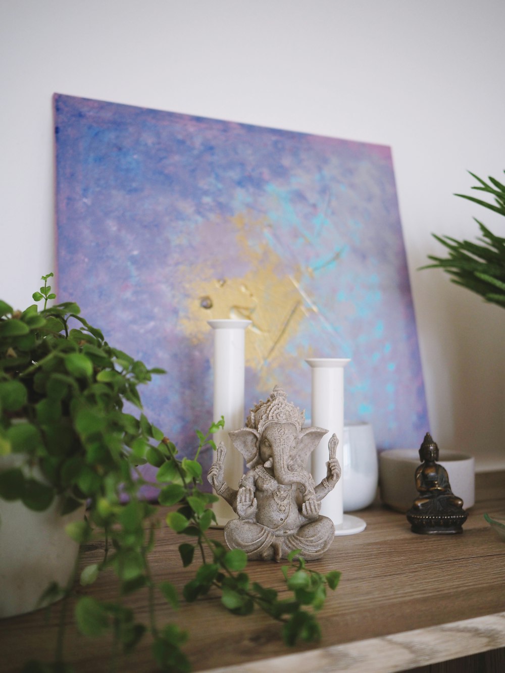 white ceramic candle holder on brown wooden table