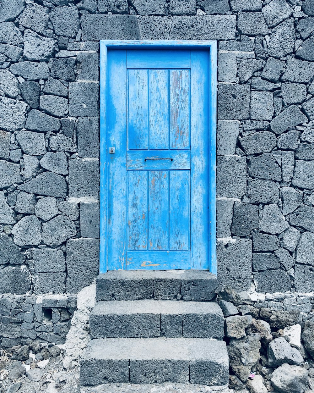 brown wooden door on gray concrete wall