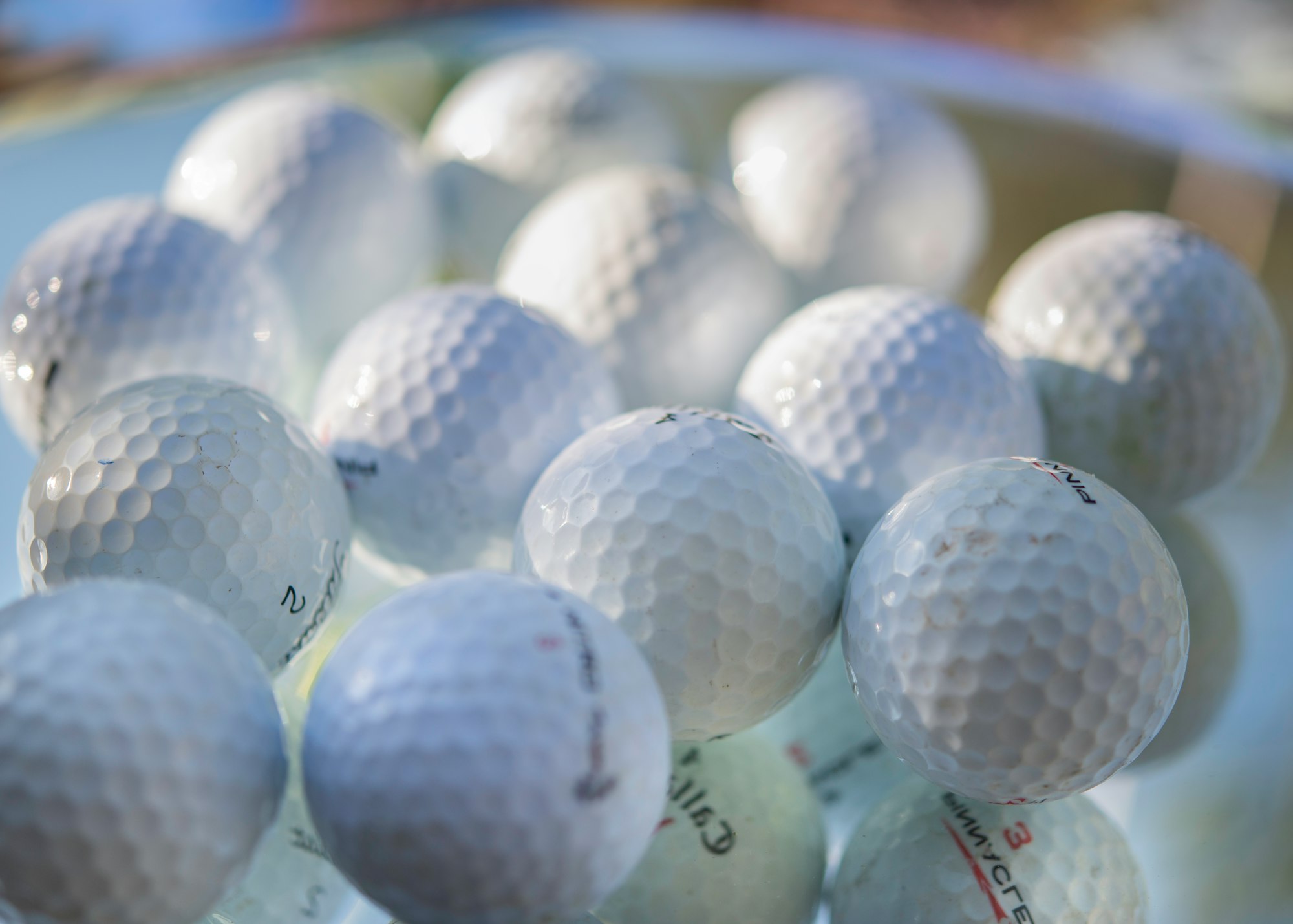 white golf ball on green golf course - best golf balls for beginners