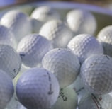 white golf ball on green golf course