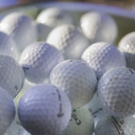 white golf ball on green golf course