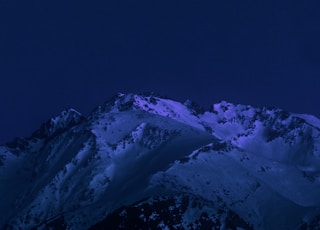 snow covered mountain under blue sky during daytime