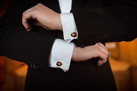 person wearing white dress shirt and black and white beaded bracelet