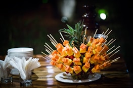 orange flowers on clear glass vase