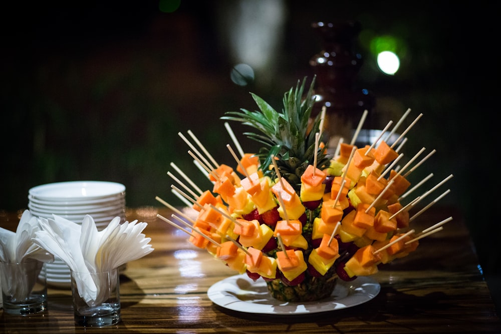 orange flowers on clear glass vase