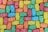 A colorful assortment of gummy bear candies arranged closely together in a uniform pattern. The candies are covered in a light dusting of sugar.