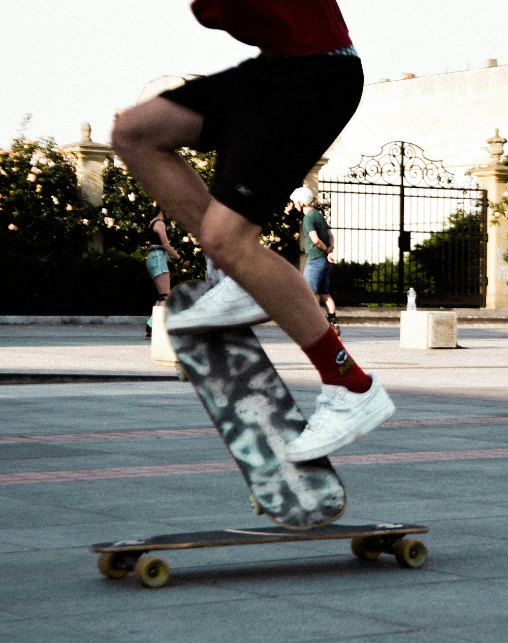 person in black shirt and white pants riding skateboard during daytime