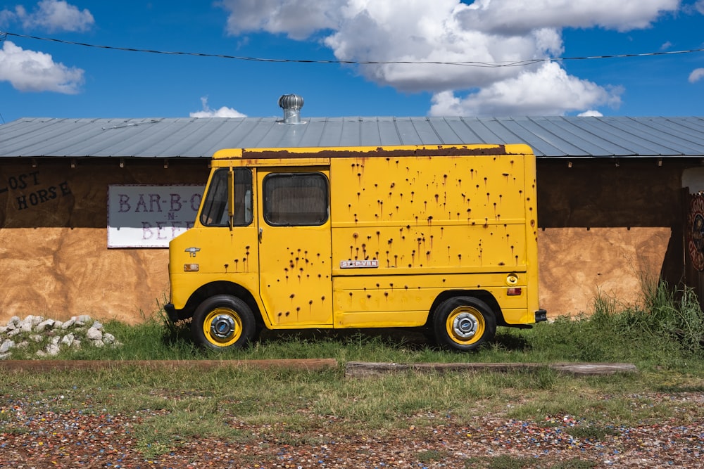 yellow van parked beside brown building