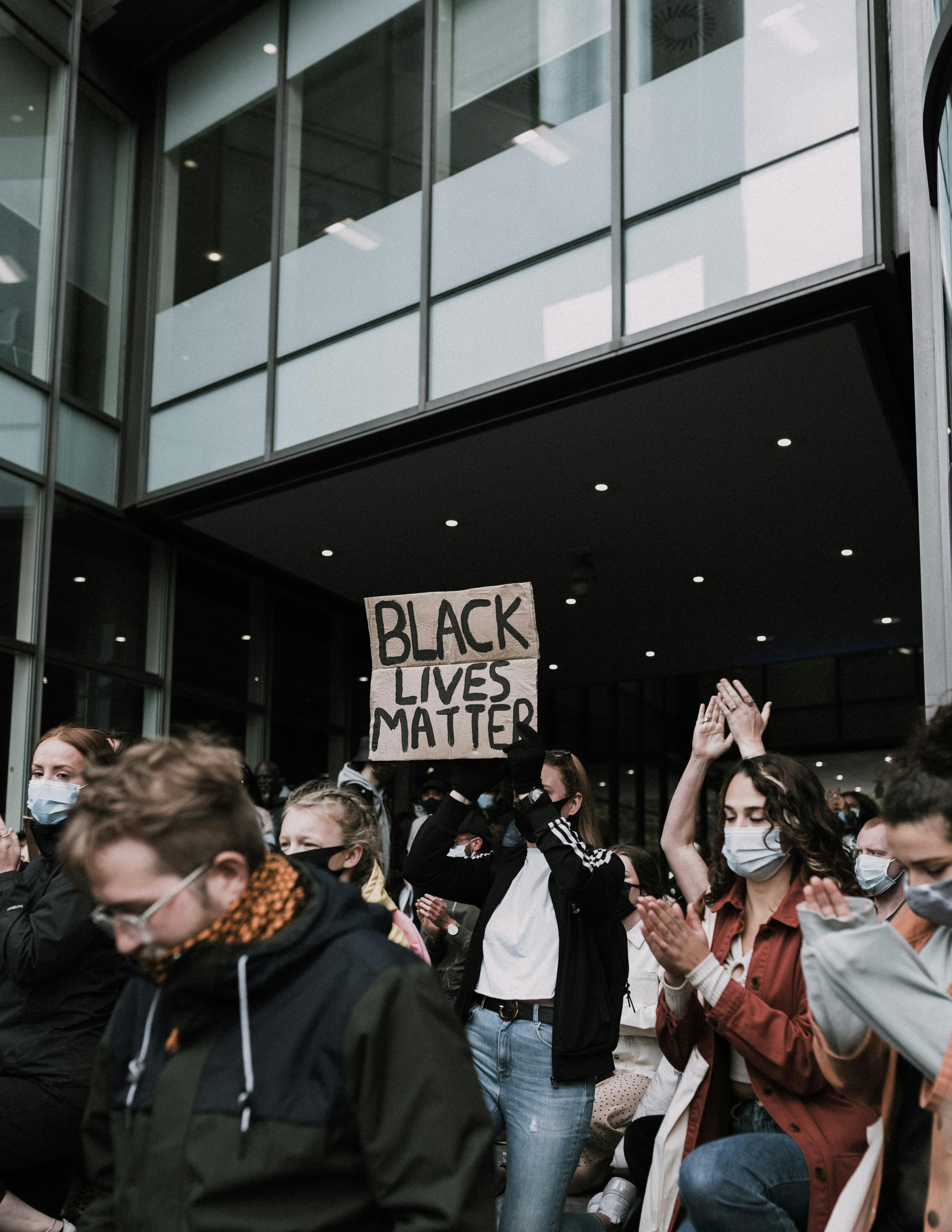 people standing near black building during daytime