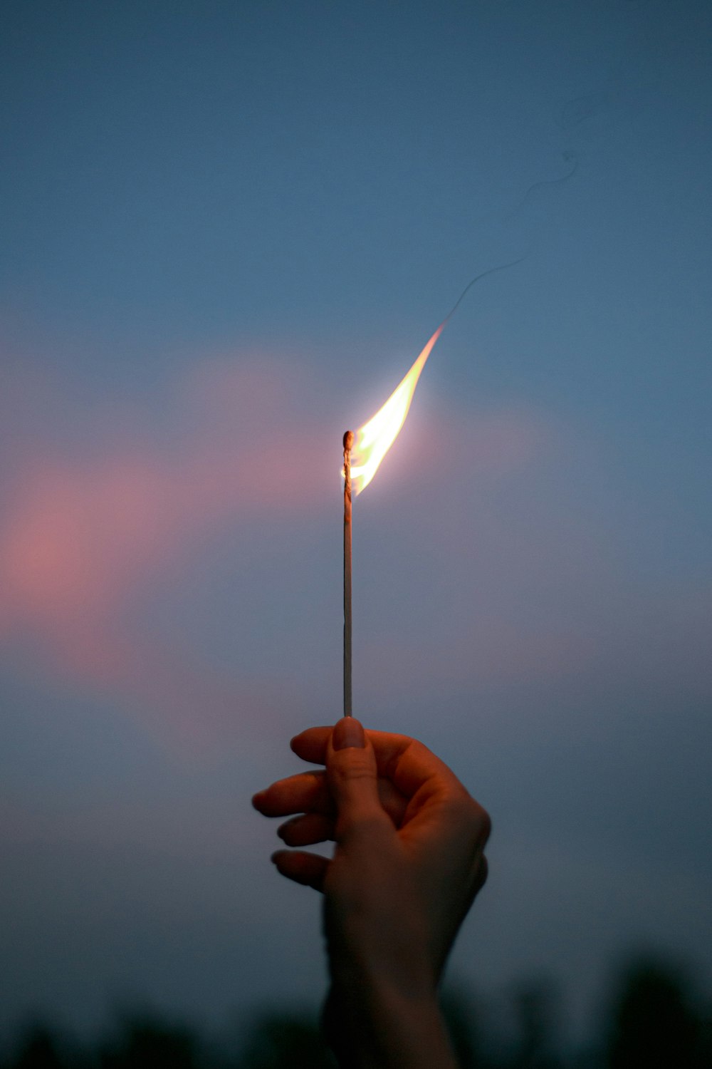 person holding lighted match stick