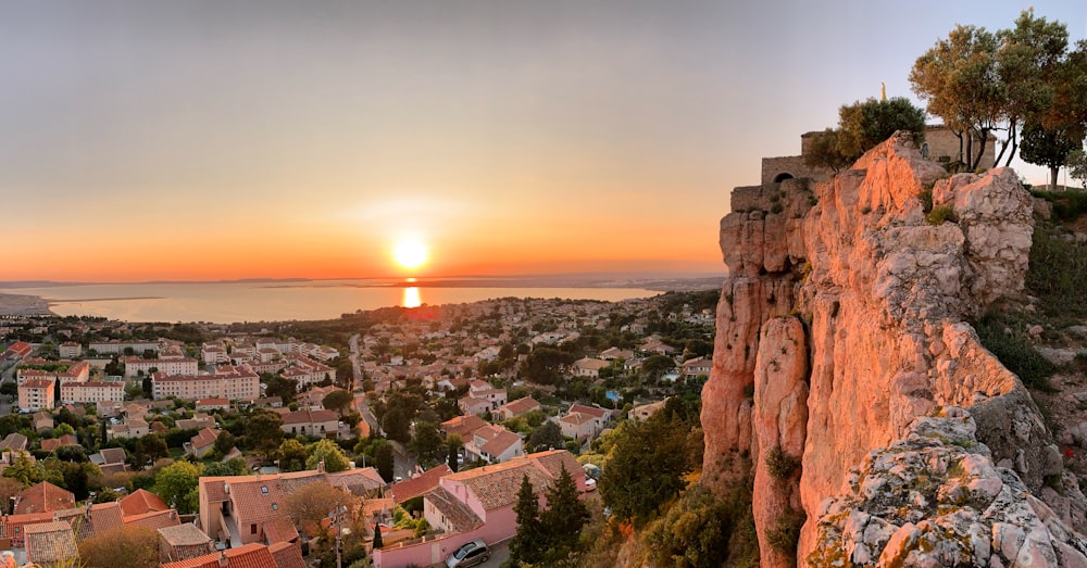 city near body of water during sunset