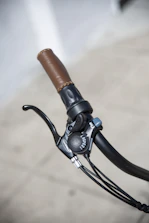 Close-up of a cyclist's hands adjusting gear on a gravel bike.