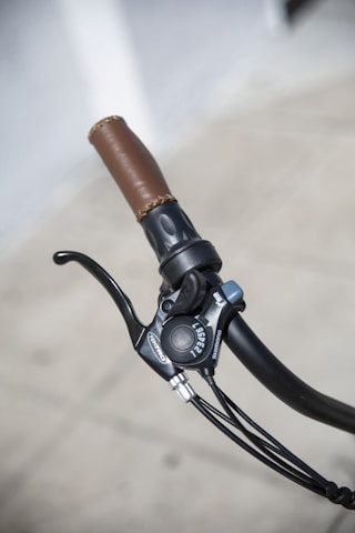 Close-up of hands adjusting gears on a sleek racing bike.