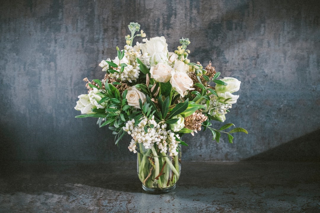 freshly trimmed white roses and lilies in a clean vase freshly trimmed white roses and lilies in a clean vase