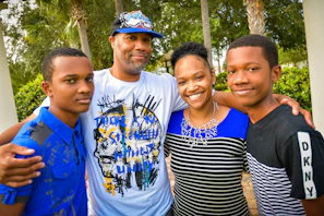A multi-generational family smiling outdoors, symbolizing protection and unity.