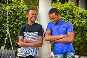 man in blue button up shirt beside woman in black and white stripe shirt