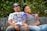 man in white crew neck t-shirt sitting beside woman in black and white stripe shirt
