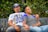 man in white crew neck t-shirt sitting beside woman in black and white stripe shirt