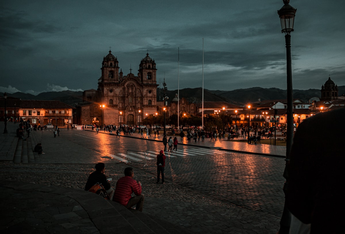 Cusco January — Plaza de Armas illuminated at night with the cathedral in moody rainy-season atmosphere
