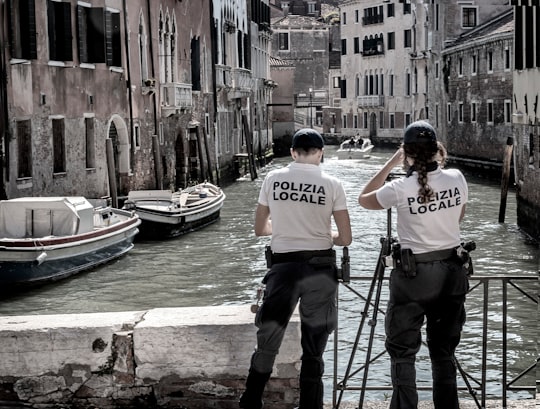 man in white crew neck t-shirt standing beside man in white t-shirt in Cannaregio Italy