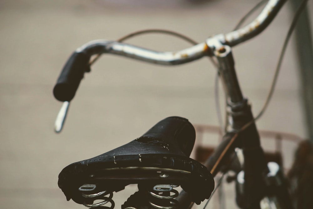 black bicycle with black and white bicycle seat