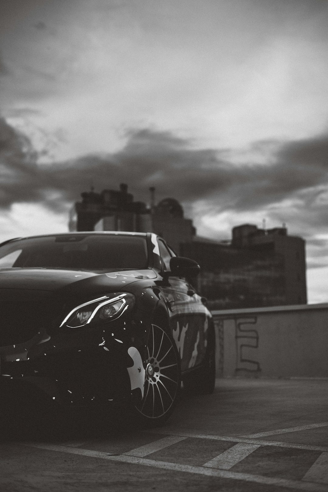 red ferrari car in grayscale photography