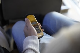 Technician using specialized equipment to measure radiation levels inside a cozy living room.
