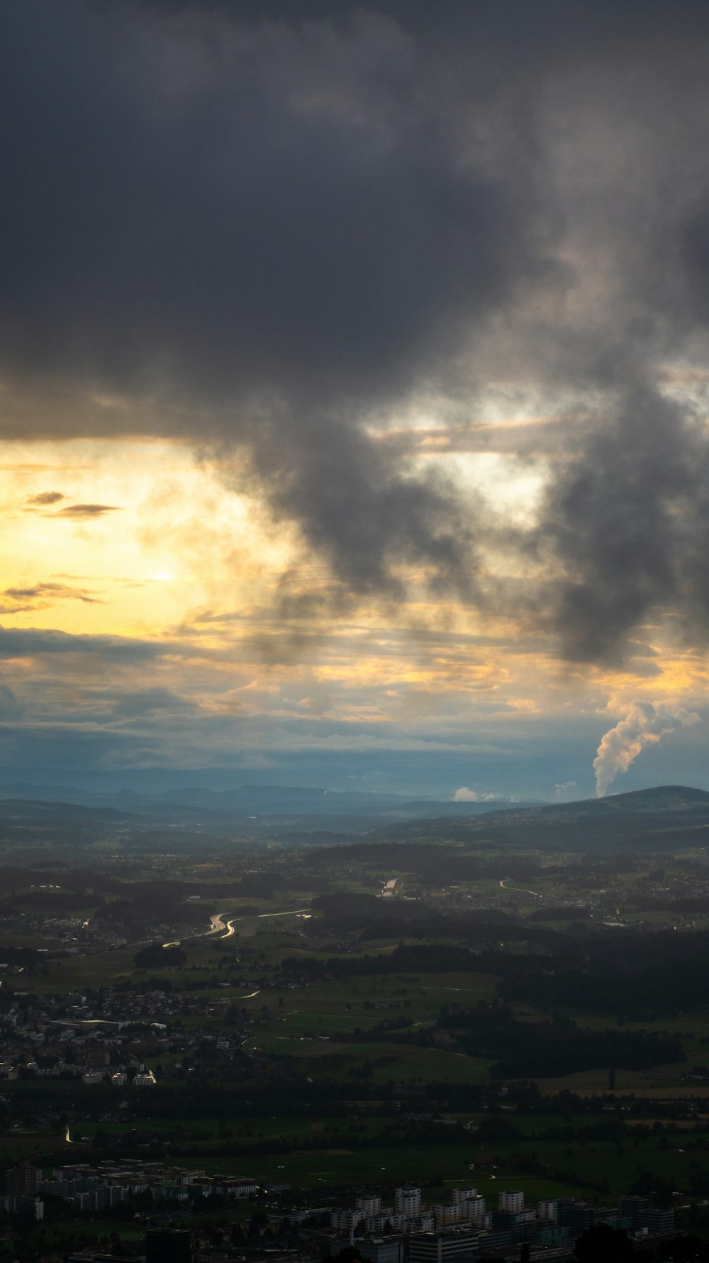 white clouds over green mountains and trees