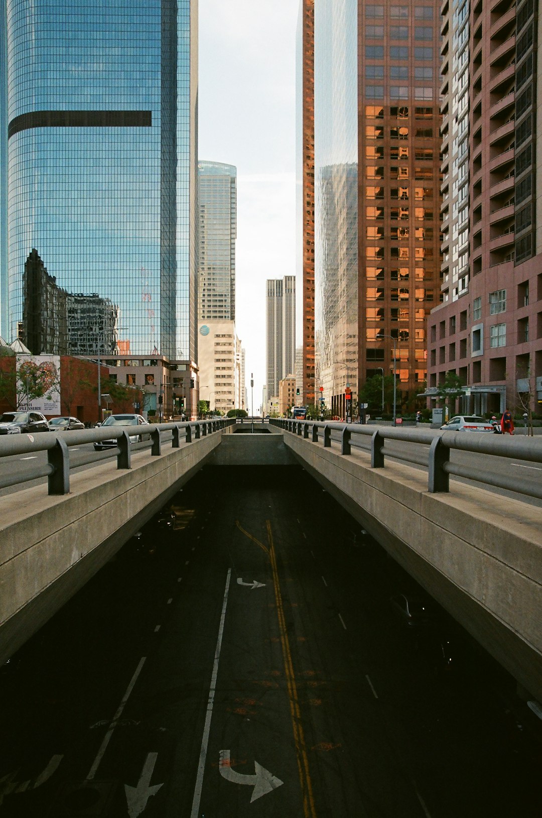 cars on road near high rise buildings during daytime