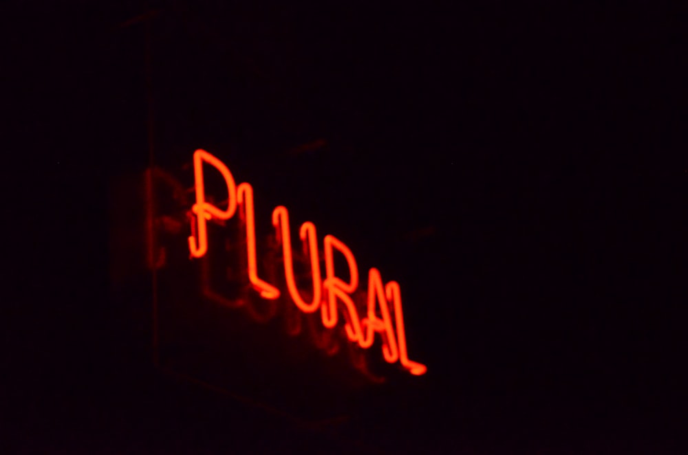 a neon sign that reads puran in the dark