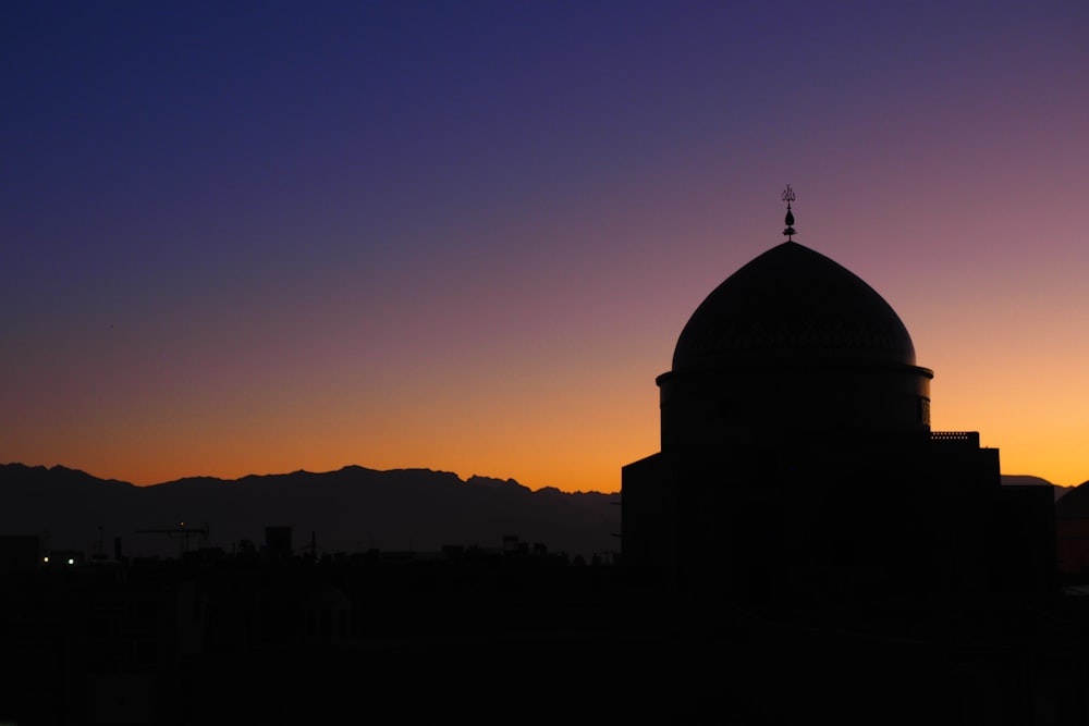 silhouette of building during sunset