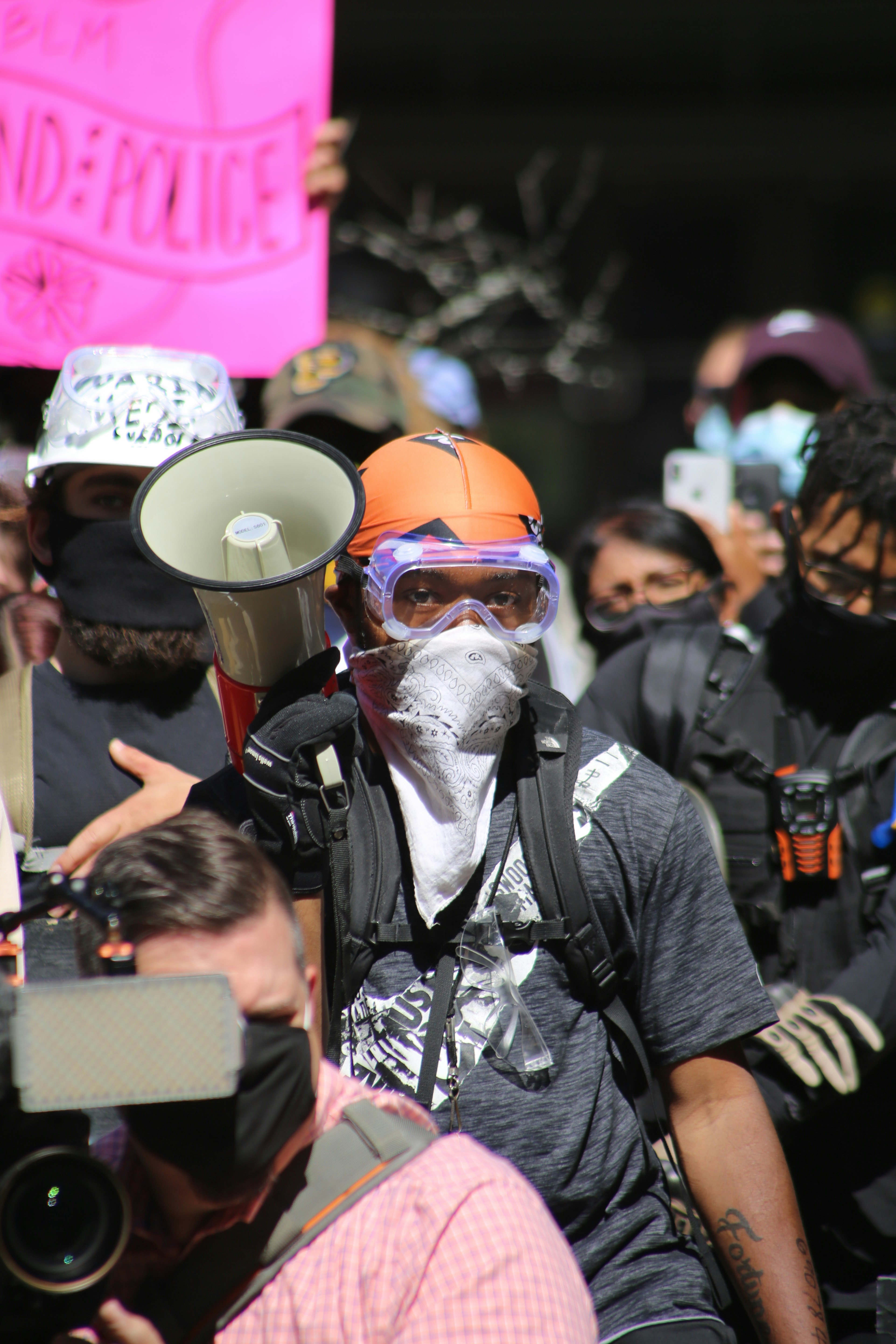 man in black jacket wearing orange helmet and goggles