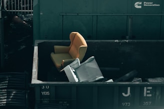 white printer paper on black plastic trash bin