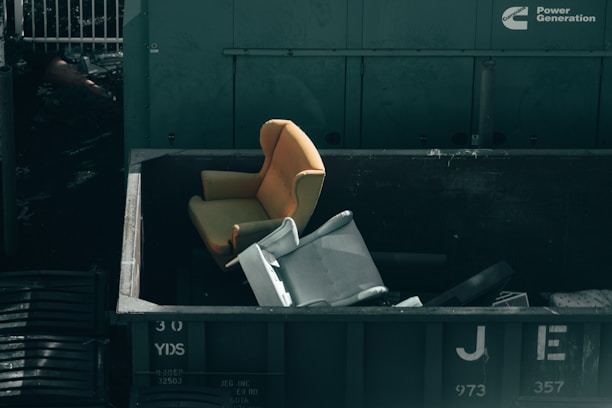 white printer paper on black plastic trash bin