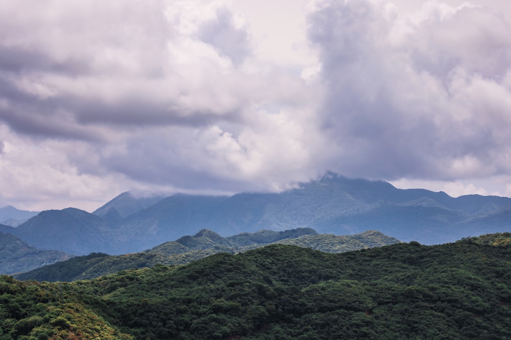 green mountains under white clouds during daytime