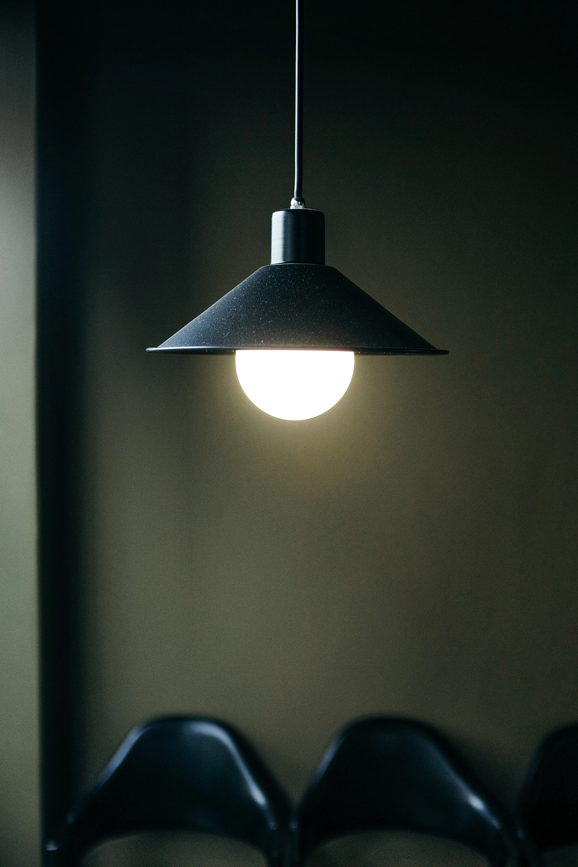 black pendant lamp turned on in room