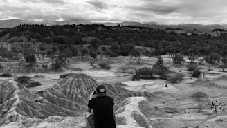 A candid photo of the founder engaging warmly with happy travelers amidst Jordan’s desert landscape.