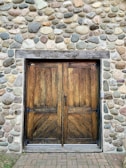 Rustic wooden door with visible knots and textures, fitting a traditional home style.