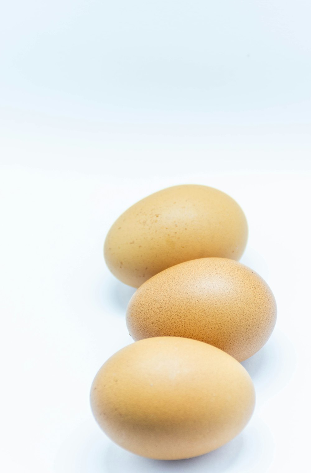 2 brown egg on white surface