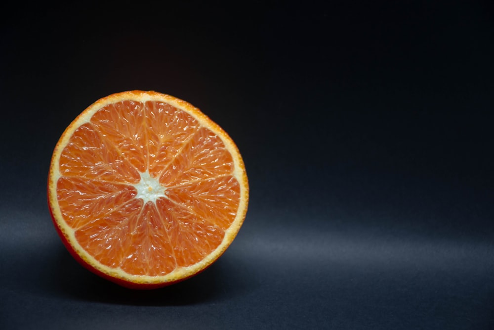 orange fruit on black surface